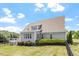 This beautiful home has a well manicured lawn with mature landscaping and deck with stairway down to the backyard at 10 Princeton Manor Dr, Youngsville, NC 27596