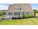 A well kept lawn with a deck and multiple windows in the rear of the house at 10 Princeton Manor Dr, Youngsville, NC 27596