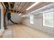 Unfinished basement featuring visible ceiling beams, vapor barrier, and support equipment at 10 Princeton Manor Dr, Youngsville, NC 27596