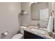 Half bath with granite countertop, under-mount sink, and modern fixtures; adjacent to a decorative mirror at 10 Princeton Manor Dr, Youngsville, NC 27596