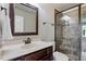 Bathroom featuring decorative vanity, glass shower, and framed mirror at 10 Princeton Manor Dr, Youngsville, NC 27596