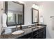 Bathroom with granite countertops, dual undermount sinks and two mirrors with decorative lighting at 10 Princeton Manor Dr, Youngsville, NC 27596