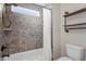 Bright bathroom with tiled shower and bathtub, featuring a small window and black fixtures at 10 Princeton Manor Dr, Youngsville, NC 27596