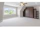 A spacious bedroom with a ceiling fan and a murphy bed bookcase at 10 Princeton Manor Dr, Youngsville, NC 27596