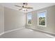 Bedroom with neutral walls, carpet flooring, ceiling fan and two windows offering natural light at 10 Princeton Manor Dr, Youngsville, NC 27596