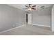 Bedroom featuring neutral walls, carpet flooring, a ceiling fan, and a doorway leading to another room at 10 Princeton Manor Dr, Youngsville, NC 27596