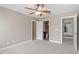 Bedroom featuring two windows and a ceiling fan, open door to ensuite bath at 10 Princeton Manor Dr, Youngsville, NC 27596