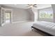 A spacious bedroom with a ceiling fan, murphy bed bookcase and adjacent room at 10 Princeton Manor Dr, Youngsville, NC 27596