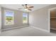 Bedroom featuring two windows and a ceiling fan, open door to walk-in closet at 10 Princeton Manor Dr, Youngsville, NC 27596
