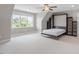 A spacious bedroom with a ceiling fan and a murphy bed bookcase folded down at 10 Princeton Manor Dr, Youngsville, NC 27596