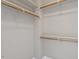 Walk-in closet with white walls, shelves, and wooden rods providing ample storage space at 10 Princeton Manor Dr, Youngsville, NC 27596