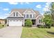 Beautiful two-story home with landscaped front yard, stone accents, and attached garage at 10 Princeton Manor Dr, Youngsville, NC 27596