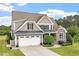 Traditional style home with stone facade, neutral colors, black shutters and an attached garage at 10 Princeton Manor Dr, Youngsville, NC 27596