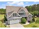 Stunning two-story home with manicured lawn, stone accents and attached two car garage at 10 Princeton Manor Dr, Youngsville, NC 27596