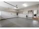 Spacious garage with epoxy floor, storage racks, and built-in shelving; perfect for organization and vehicle storage at 10 Princeton Manor Dr, Youngsville, NC 27596