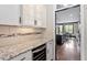 Gourmet kitchen featuring granite counters, stainless steel appliances, wine cooler and glass front cabinets at 10 Princeton Manor Dr, Youngsville, NC 27596
