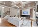 Sophisticated living room with fireplace, coffered ceiling and stairs at 10 Princeton Manor Dr, Youngsville, NC 27596