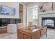 Cozy living room showcasing a fireplace, textured wall, and stylish decor at 10 Princeton Manor Dr, Youngsville, NC 27596