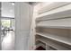 Walk-in pantry with custom shelving in modern kitchen at 10 Princeton Manor Dr, Youngsville, NC 27596
