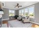 Bright sunroom featuring large windows, hardwood floors, and comfortable seating at 10 Princeton Manor Dr, Youngsville, NC 27596