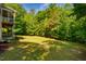 A shot of the rear lawn surrounded by wooded areas and natural features at 100 Panoramic Ct, Cary, NC 27519