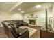 Finished basement with fireplace and large leather sofa; home theater area at 100 Panoramic Ct, Cary, NC 27519