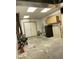 Spacious unfinished basement area with concrete floor, storage cabinets, and double door access at 100 Panoramic Ct, Cary, NC 27519