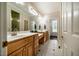 Bathroom featuring double sinks, wood cabinets, a large mirror and a tile floor at 100 Panoramic Ct, Cary, NC 27519