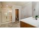 Bathroom featuring glass-doored shower, vanity with marble countertop, and stone floors at 100 Panoramic Ct, Cary, NC 27519