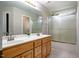 Spacious bathroom with double sinks, tile flooring, and a glass-enclosed shower at 100 Panoramic Ct, Cary, NC 27519