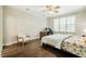 Bright bedroom with a ceiling fan, wooden floors, desk, and a large window for natural light at 100 Panoramic Ct, Cary, NC 27519