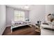 Cozy bedroom with a white twin bed, desk, and large window providing natural light at 100 Panoramic Ct, Cary, NC 27519