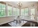Cozy breakfast nook features a chandelier and multiple windows offering natural light and scenic views at 100 Panoramic Ct, Cary, NC 27519