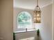 Elegant entryway with a decorative chandelier, arched window, and stairway at 100 Panoramic Ct, Cary, NC 27519