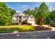 Charming two-story home with a well-manicured lawn and mature trees providing shade at 100 Panoramic Ct, Cary, NC 27519