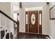 Inviting foyer with hardwood floors, an elegant door, and staircase at 100 Panoramic Ct, Cary, NC 27519