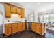Well-lit kitchen featuring wooden cabinets, quartz countertops, subway tile backsplash, and modern appliances at 100 Panoramic Ct, Cary, NC 27519