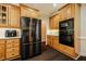 Functional kitchen with stainless steel appliances, wood cabinetry, and subway tile, offering ample storage space at 100 Panoramic Ct, Cary, NC 27519
