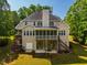 The home's rear exterior features an elevated deck, screened porch, and lawn at 100 Panoramic Ct, Cary, NC 27519