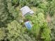 Aerial view of a house surrounded by lush trees, complete with a swimming pool and a spacious backyard at 1000 Phils Creek Rd, Chapel Hill, NC 27516