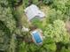 This home has a swimming pool and a well-maintained lawn in a serene, wooded setting at 1000 Phils Creek Rd, Chapel Hill, NC 27516