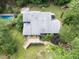 Aerial view showcases a home with a pool, spacious yard, deck, and lush, mature landscaping at 1000 Phils Creek Rd, Chapel Hill, NC 27516