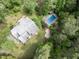 Aerial view of a home featuring a pool and lush greenery, offering a private retreat at 1000 Phils Creek Rd, Chapel Hill, NC 27516