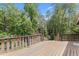 Backyard featuring a wooden deck with stairs, beautiful trees, and a serene outdoor setting at 1000 Phils Creek Rd, Chapel Hill, NC 27516