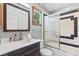 Updated bathroom with modern vanity, wood trim and tiled shower and bathtub at 1000 Phils Creek Rd, Chapel Hill, NC 27516