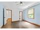 Bright bedroom features hardwood floors, a ceiling fan, and ensuite bathroom at 1000 Phils Creek Rd, Chapel Hill, NC 27516