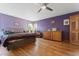 Cozy bedroom with hardwood floors, a large bed, and natural light at 1000 Phils Creek Rd, Chapel Hill, NC 27516
