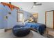 Bedroom with blue walls, a fan, and hardwood floors, providing a tranquil retreat at 1000 Phils Creek Rd, Chapel Hill, NC 27516