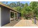 Exterior of home featuring a wooden deck with a sliding glass door leading indoors and view of backyard at 1000 Phils Creek Rd, Chapel Hill, NC 27516