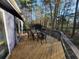 Wooden deck with table and chairs, ideal for outdoor dining and entertaining at 1000 Phils Creek Rd, Chapel Hill, NC 27516